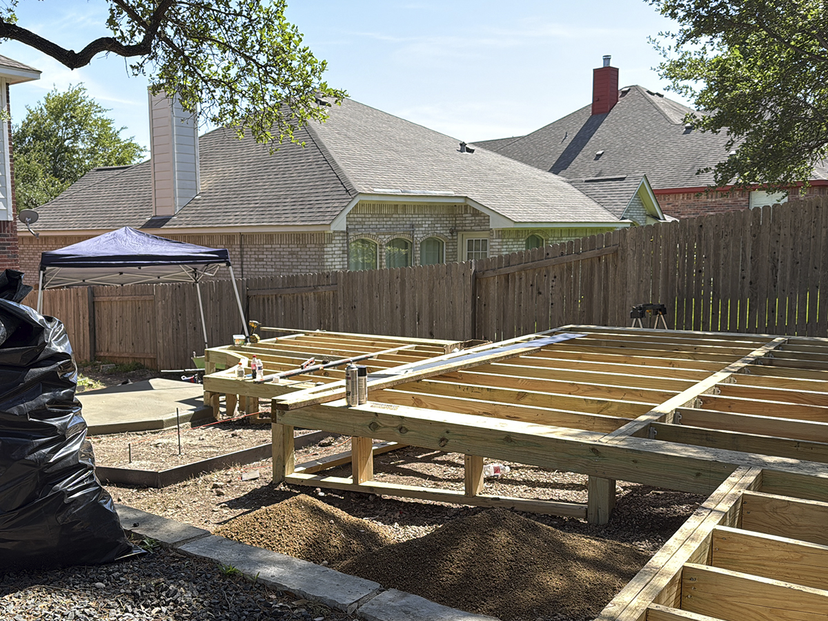 Landscape construction crew building an outdoor kitchen in Austin TX